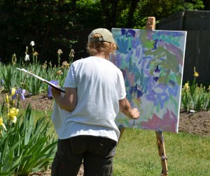 artist painting a scene of flowers