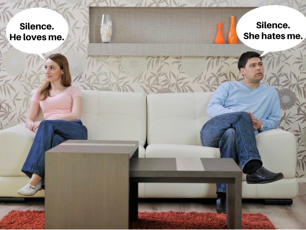 Couple on sofa. Introvert thinks "Silence. He loves me." Extrovert thinks, "Silence. She hates me."