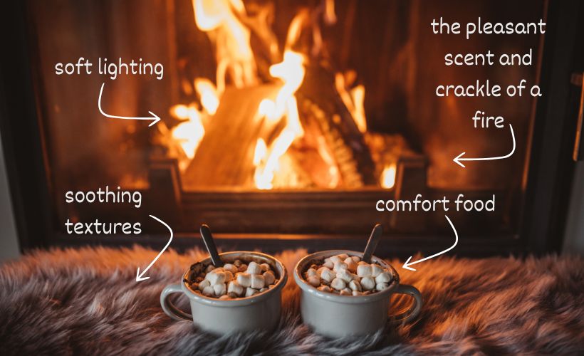 A fireside scene shows how coziness is created using the five senses, from the soft light of the fire to the comfy texture of a blanket.