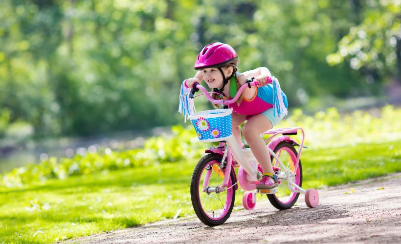 Little girl riding a bike.